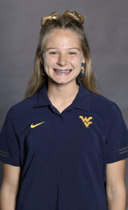 Zara standing for a professional headshot wearing West Virginia clothing