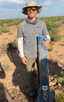 Mitch holding the booster of Competition Rocket Blue Ridge Blazer after recovering it in the New Mexico Desert, Truth or Consequences